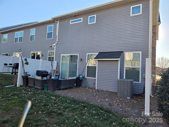 rear view of property featuring central AC and an outdoor hangout area