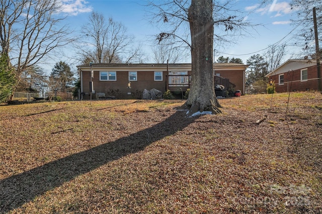 rear view of house with a wooden deck