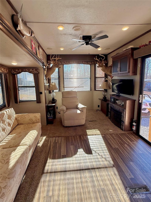 living room featuring ceiling fan, crown molding, and hardwood / wood-style floors