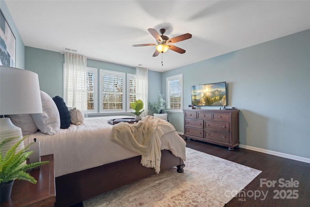 bedroom with ceiling fan and dark hardwood / wood-style flooring