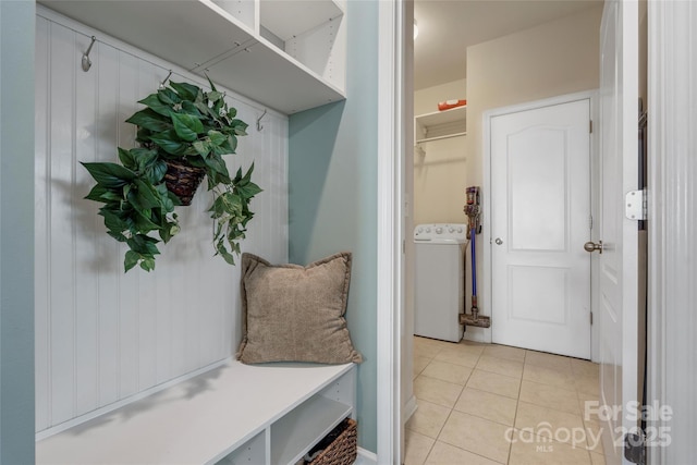 mudroom with light tile patterned floors and washer / dryer