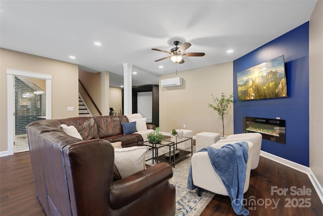 living room featuring dark wood-type flooring, ceiling fan, and an AC wall unit