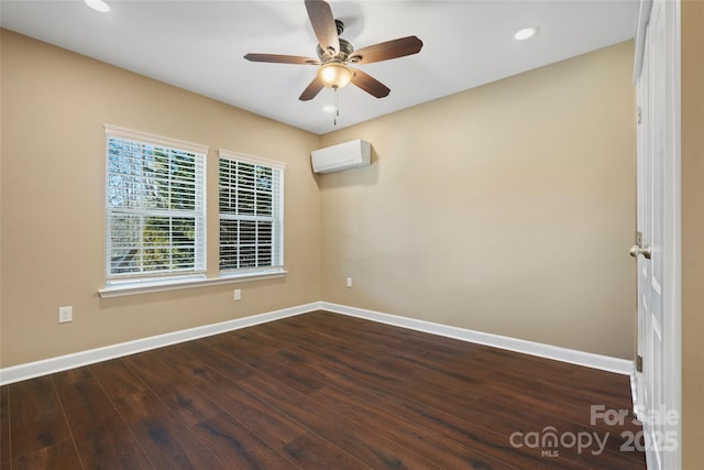 spare room featuring dark hardwood / wood-style floors, a wall mounted air conditioner, and ceiling fan