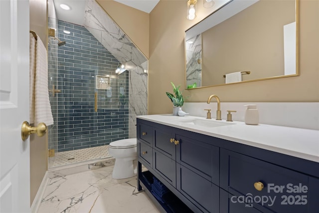 bathroom with vanity, toilet, and tiled shower