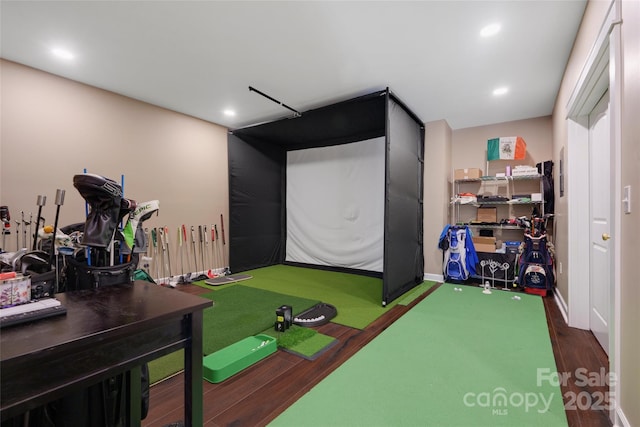 recreation room with golf simulator and dark hardwood / wood-style flooring