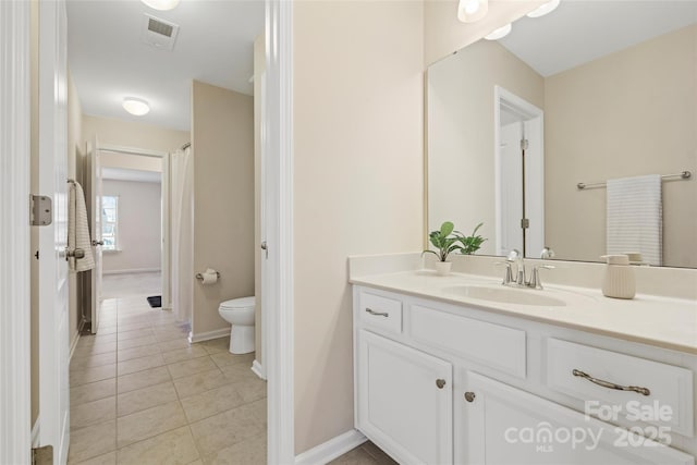 bathroom with vanity, tile patterned floors, and toilet