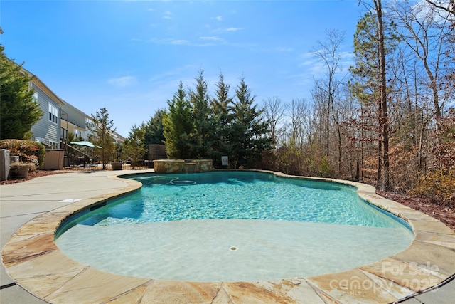 view of swimming pool with a patio area