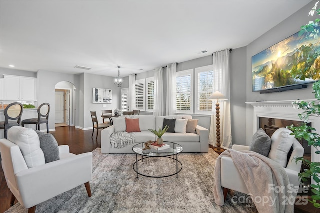 living room with hardwood / wood-style floors and a notable chandelier