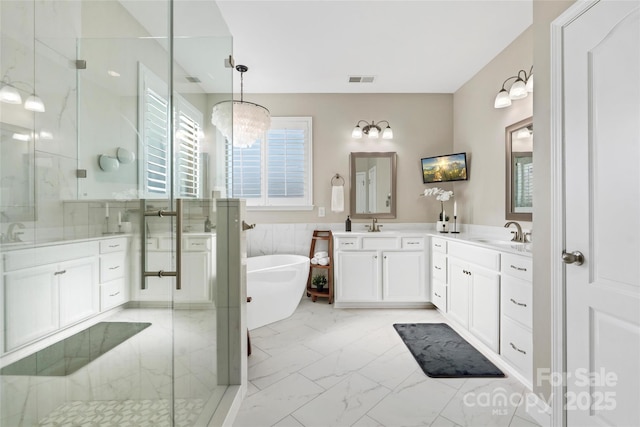 bathroom featuring a freestanding tub, visible vents, marble finish floor, a stall shower, and vanity