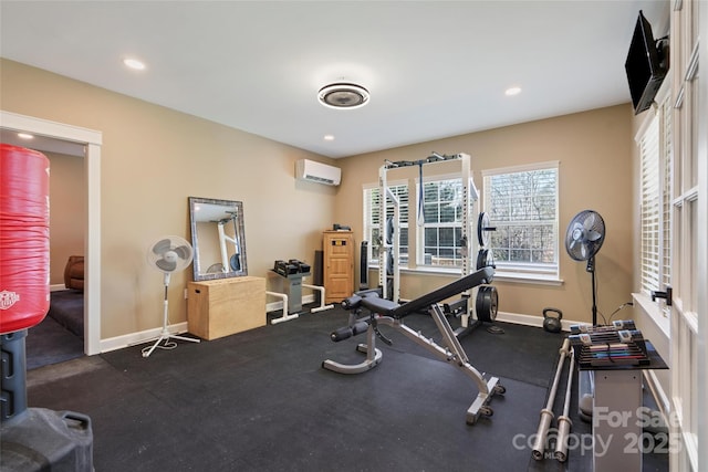 exercise area with recessed lighting, a wall mounted AC, and baseboards