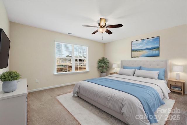 bedroom with ceiling fan, light colored carpet, visible vents, and baseboards