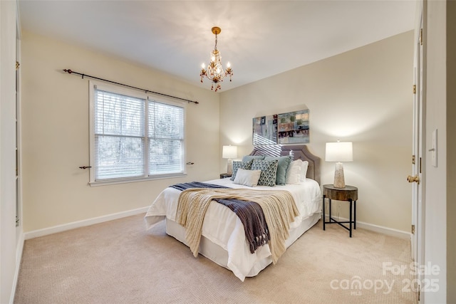 carpeted bedroom with a notable chandelier