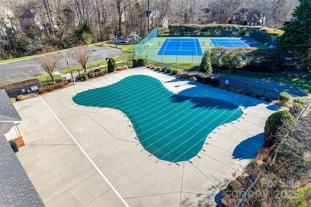 view of pool featuring tennis court