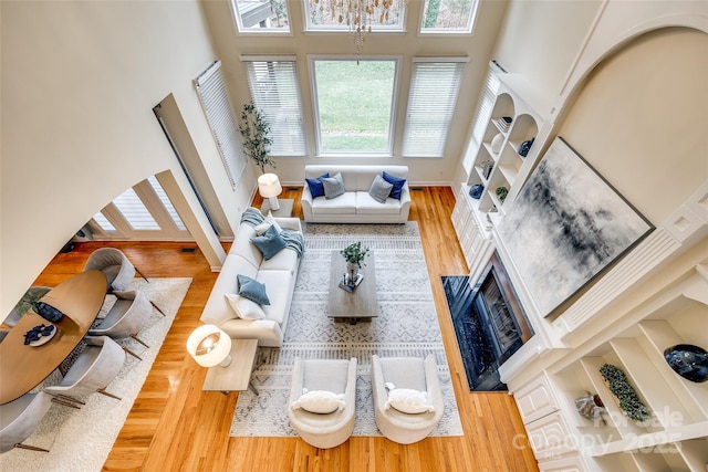 living room featuring wood-type flooring and a high ceiling