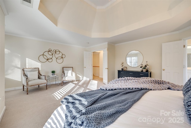 bedroom featuring ornamental molding, carpet floors, and a tray ceiling