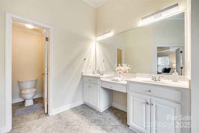 bathroom with toilet, tile patterned flooring, crown molding, and vanity