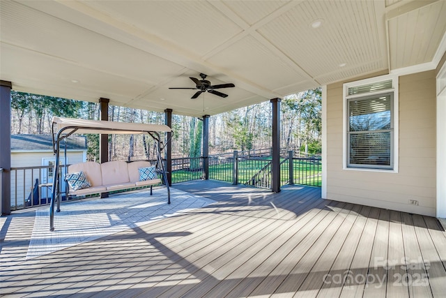 deck with ceiling fan and outdoor lounge area