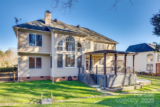 rear view of property with a lawn and a porch