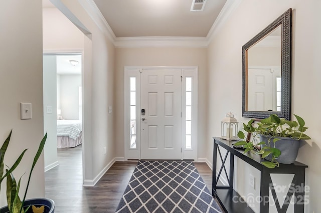 entrance foyer with ornamental molding and dark hardwood / wood-style flooring