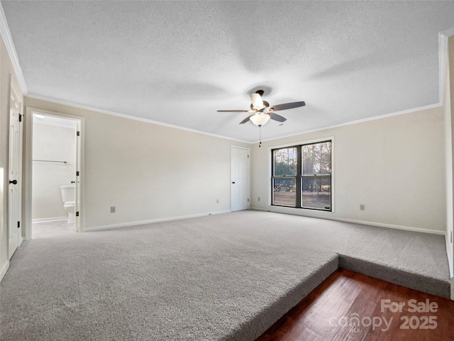 unfurnished room featuring carpet flooring, a textured ceiling, ornamental molding, and ceiling fan