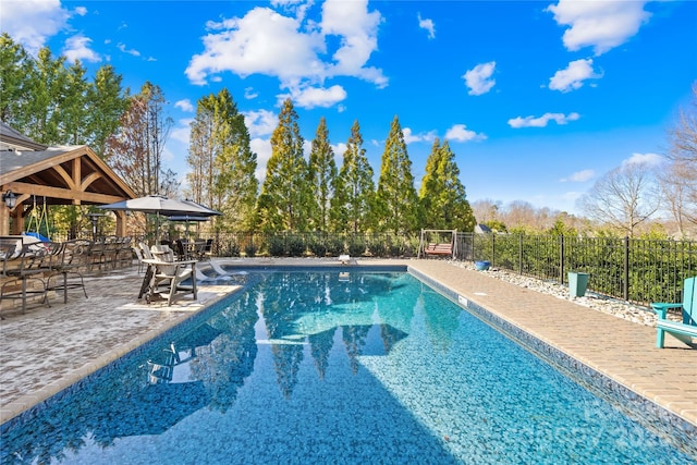 view of swimming pool featuring a patio and a gazebo