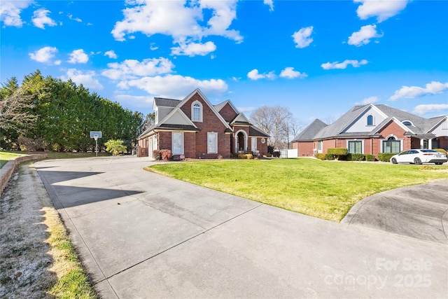 view of front of house with brick siding, a garage, concrete driveway, and a front lawn