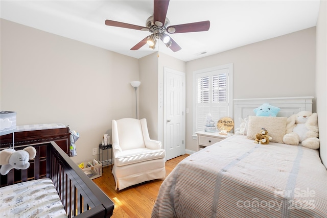 bedroom featuring visible vents, light wood-type flooring, and a ceiling fan