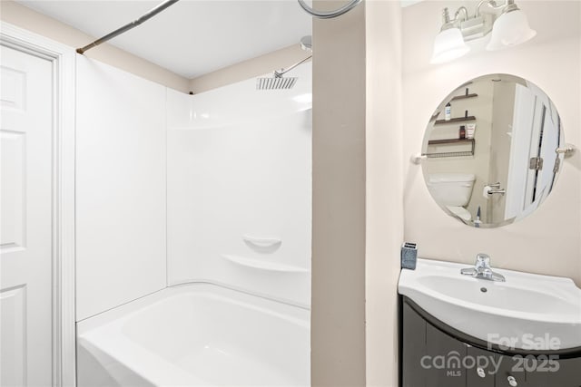 bathroom featuring toilet, bathtub / shower combination, and vanity