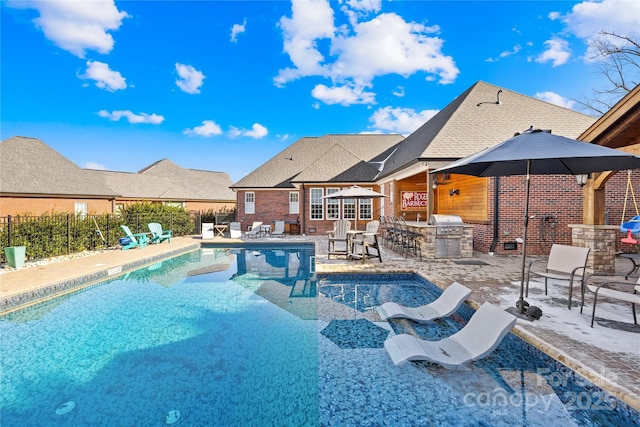 view of swimming pool with a patio, area for grilling, exterior kitchen, and fence