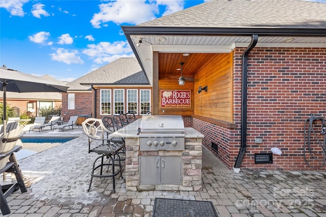 view of patio featuring grilling area, exterior bar, and exterior kitchen