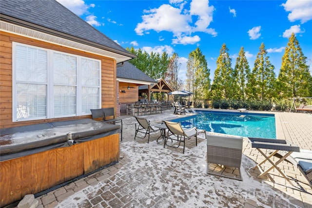 view of swimming pool featuring a fenced in pool, a patio, a hot tub, and fence