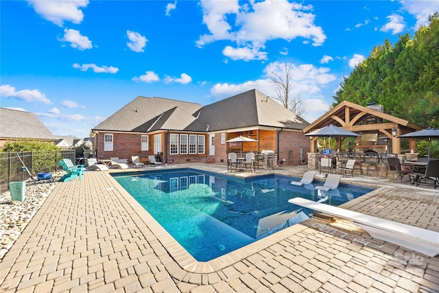 view of swimming pool with outdoor dining area, a patio area, fence, and a fenced in pool