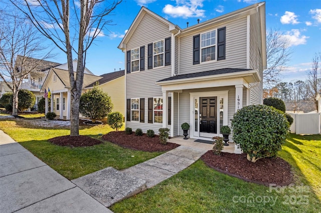 view of property featuring a front lawn