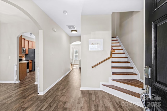 entryway with dark wood-type flooring