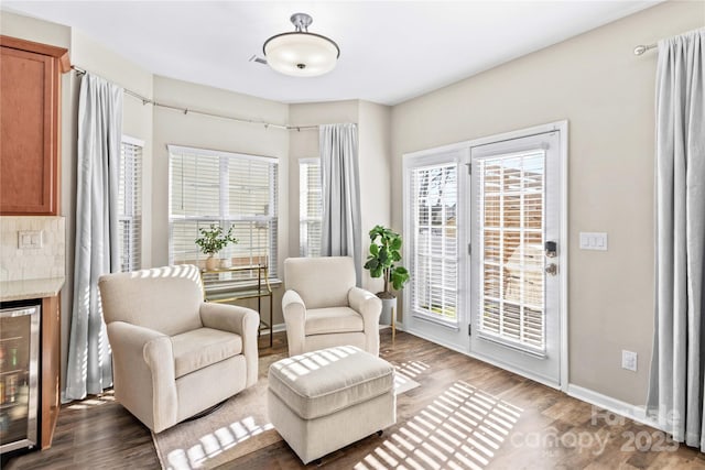 living area with wine cooler and dark hardwood / wood-style floors