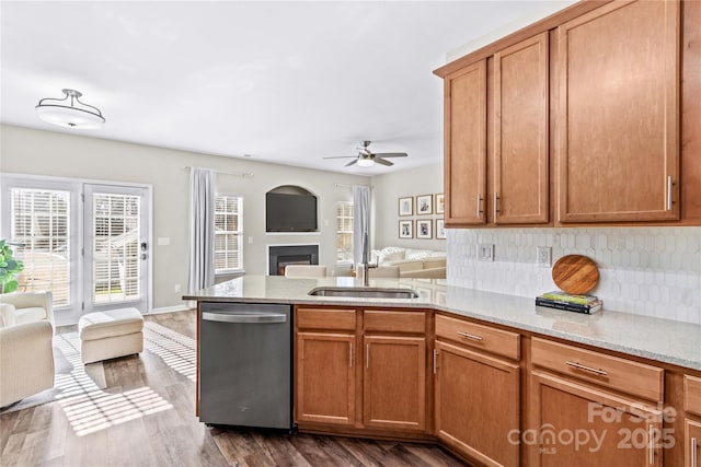 kitchen featuring ceiling fan, backsplash, dishwasher, sink, and dark hardwood / wood-style flooring