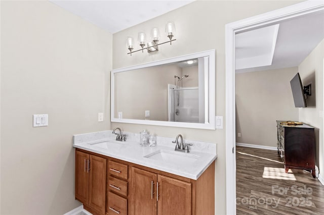 bathroom with walk in shower, wood-type flooring, and vanity