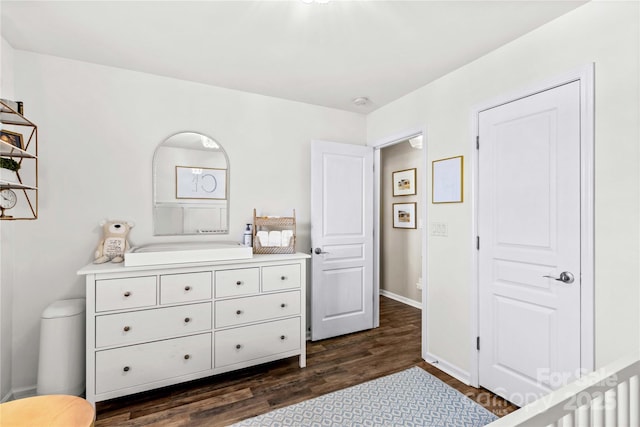 bedroom with dark wood-type flooring