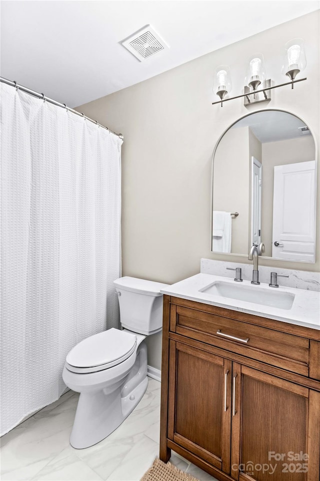 bathroom featuring toilet and vanity