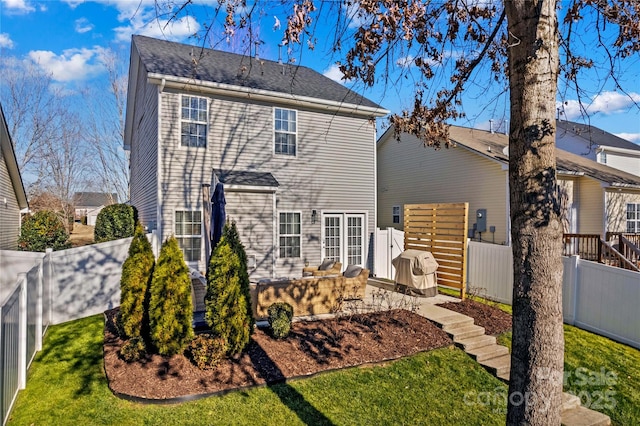 back of house with a patio area and a yard