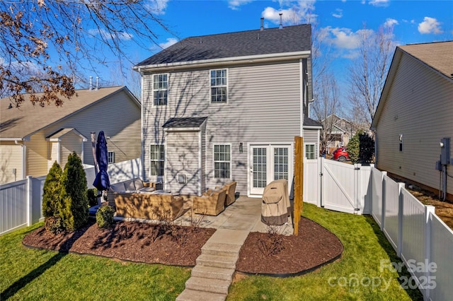 rear view of house with a yard and a patio