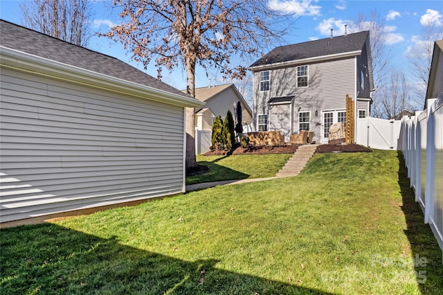 rear view of house featuring a yard