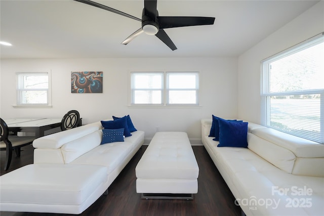 living room with ceiling fan and dark wood-type flooring