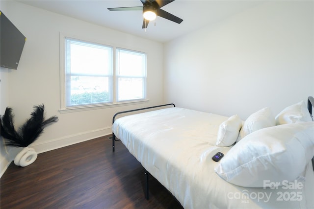 bedroom featuring ceiling fan and dark hardwood / wood-style flooring