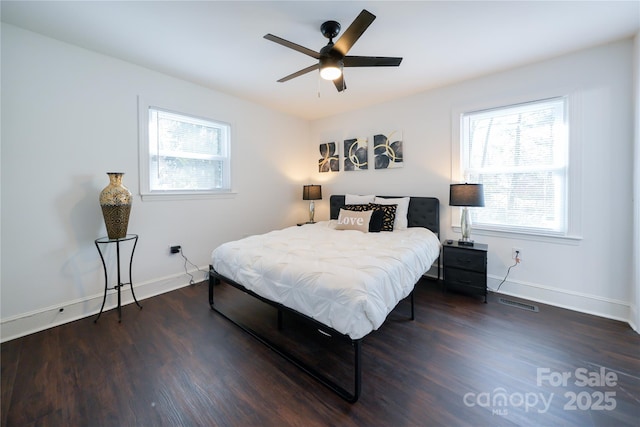 bedroom with ceiling fan and dark hardwood / wood-style floors