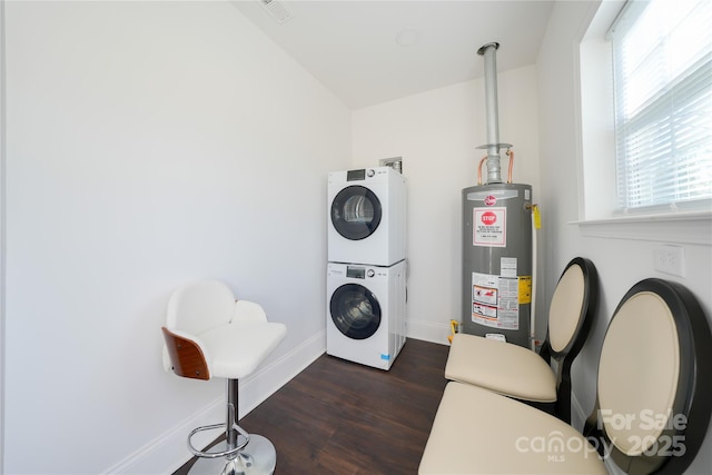 clothes washing area with dark hardwood / wood-style flooring, gas water heater, and stacked washer / dryer