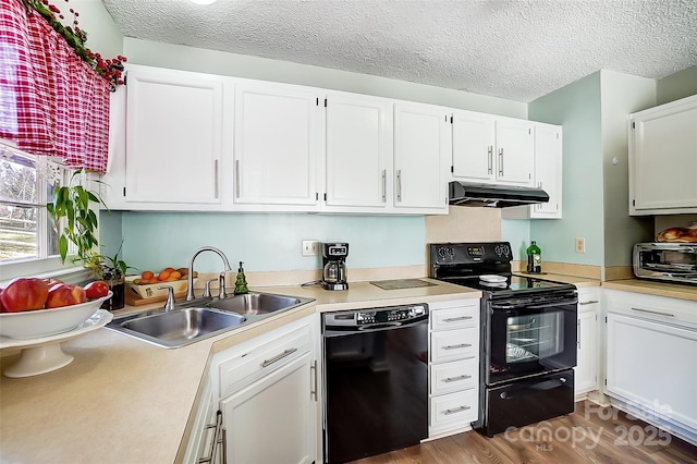 kitchen with a textured ceiling, white cabinets, black appliances, sink, and dark hardwood / wood-style floors