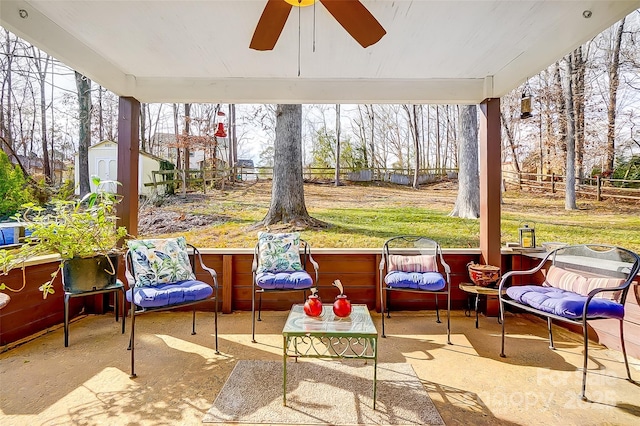 sunroom featuring ceiling fan