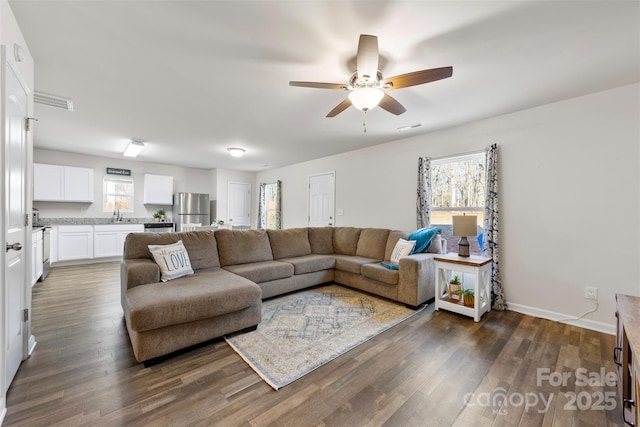 living room with ceiling fan and dark hardwood / wood-style floors