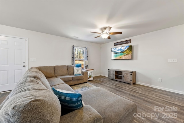 living room featuring wood-type flooring and ceiling fan